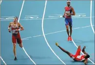  ?? LOIC VENANCE / AGENCE FRANCE-PRESSE ?? Trinidad and Tobago’s Jehue Gordon (right) trips after winning the men’s 400m hurdles in Moscow on Thursday.