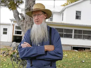  ?? AMY SANCETTA/ AP ?? Samuel Mullet Sr. stands in front of his home in Bergholz, Ohio, in 2011. The 74-year-old Amish bishop has asked to be released from federal custody early because of the coronaviru­s.