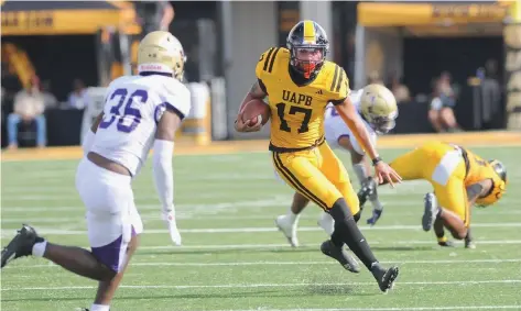  ?? (Special to the Commercial/William Harvey) ?? UAPB quarterbac­k Chancellor Edwards (right) carries the ball while guarded by Alcorn State defender Kayvon Henderson (left) during an Oct. 21 football game.