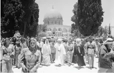  ?? Getty ?? Jordan’s King Abdullah I, centre, walks to Al Aqsa mosque to pray in June 1948. He would be killed there three years later