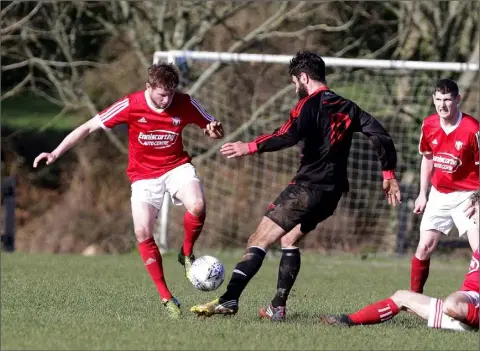  ??  ?? James Peare of Moyne Rangers and Dan Murphy of Bridge Rovers keep their eyes on the ball.