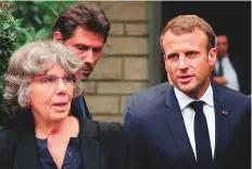  ?? AFP ?? Emmanuel Macron (right) walks with Michele Audin, daughter of the late Maurice Audin, as he leaves the home of Josette Audin, widow of Audin, yesterday.