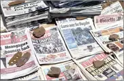  ?? PHOTO: AP ?? Newspapers held down by rocks in Harare, Zimbabwe, yesterday. President Robert Mugabe ignored a midday deadline set by the ruling party to step down or face impeachmen­t.