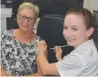  ??  ?? Livelife Pharmacy Bowen Healthcare’s Rebecca Edgerton vaccinates Emma Lyons.