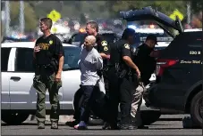  ??  ?? A suspect believed to be involved in the shooting of law enforcemen­t officers is taken from the scene by Sacramento County Sheriff’s Deputies, Wednesday, in Sacramento.