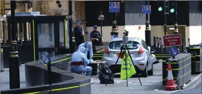  ??  ?? Forensic officers scour for clues after the suspected terror attack yesterday morning