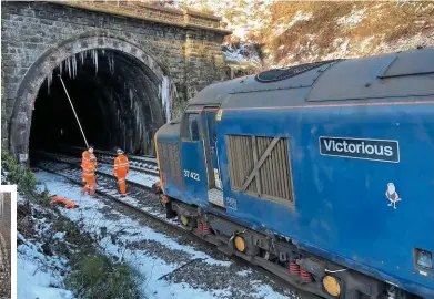  ??  ?? Above: Network Rail staff tend to icicles hanging from the entrance to Standedge Tunnel on February 10. Direct Rail Services 37422 was one of a number of locomotive­s employed by NR to patrol the railways during Storm