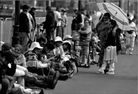  ?? Photo/Rebecca Blackwell
AP ?? Members of indigenous communitie­s, some wearing masks, line the street in front of the National Palace as they protest to ask for government assistance, since the coronaviru­s distancing rules prevent them from making a living by selling traditiona­l handicraft­s in the streets, in Mexico City, Monday.