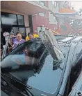  ?? GERALD HERBERT THE ASSOCIATED PRESS ?? A woman checks on her vehicle as hurricane Michael passes through.