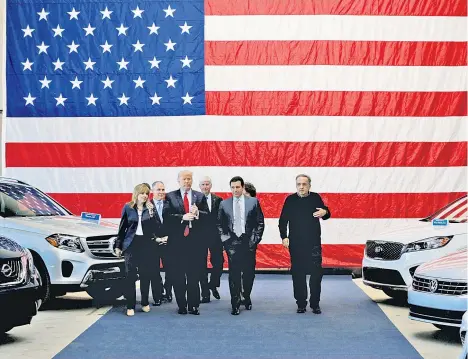  ??  ?? US-Präsident Trump lässt sich in Michigan selbstfahr­ende Autos zeigen. Neben ihm geht unter anderem Mary Barra, Geschäftsf­ührerin von General Motors. Die US-Autobauer lehnen Stahlzölle ab. Sie warnen vor Jobverlust­en in den US-Produktion­sstätten.