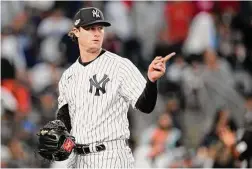  ?? Brett Coomer/Houston Chronicle ?? Yankees pitcher Gerrit Cole (45) points to the outfield after getting the Astros Alex Bregman to fly out in the third inning during Game 3 of the ALCS at Yankee Stadium on Oct. 22.