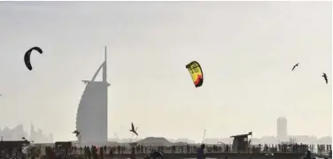  ?? File/ Agence France-presse ?? A picture shows kiteboarde­rs in front of Burj Al Arab in Dubai.