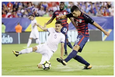  ??  ?? Eric Lichaj (15) of the US kicks a goal against El Salvador’s Ivan Mancia during a CONCACAF Gold Cup quarterfin­al soccer match in Philadelph­ia Wednesday. (AP)