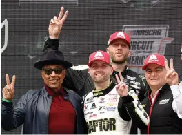  ?? (Sean Gardner photos/getty Images) ?? William Byron (foreground, center), driver of the #24 Raptortoug­h.com Chevrolet, celebrates with Grand Marshal Giancarlo Esposito (left) and Jeff Gordon, Vice Chairman of Hendrick Motorsport­s (right), in Victory Lane after winning Sunday’s Cup Series Echopark Automotive Grand Prix at Circuit of The Americas.