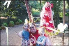  ?? (NWA Democrat-Gazette/Carin Schoppmeye­r) ?? Kendall Roberson (from left), Jessica Roberson and Austin Roberson stop for a photo with Tabatha Taylor (Fairy Rose) at the Botanical Garden of the Ozarks.