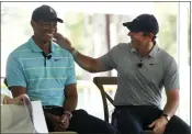  ?? WILFREDO LEE — THE ASSOCIATED PRESS ?? Tiger Woods, left, and Rory McIlroy share a laugh Tuesday at Palm Beach State College, the future home of their tech-infused golf league that will begin play next year.