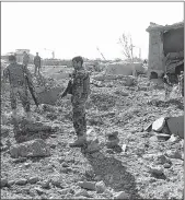  ??  ?? Afghan security personnel walk at the site of a suicide attack at a police training centre in Gardez, capital of Paktia province, on Tuesday.