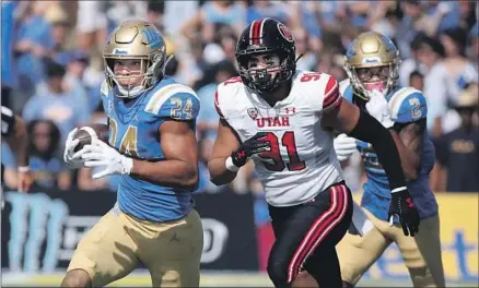  ?? Photograph­s by Luis Sinco Los Angeles Times ?? ZACH CHARBONNET breaks off a big chunk of his career-high 198 yards, in 22 carries, in UCLA’s biggest win of the Chip Kelly era.