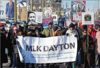  ?? CHUCK HAMLIN / STAFF ?? Hundreds of people gathered in Dayton on Monday morning to march in celebratio­n of Martin Luther King Jr. The marchers started near The Charles Drew Health Center on West Third Street and ended at the Dayton Convention Center.