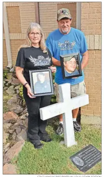  ?? STACI VANDAGRIFF/RIVER VALLEY & OZARK EDITION ?? Tonya and Harold McGary of Searcy hold photos of their son, Will, at a memorial site at their church, Valley Baptist Church in Searcy. Will, who was a Conway police officer, was directing traffic after a vehicle accident Jan. 31, 2013, when an impaired driver hit him. Will, 26, died the next day. His family and friends started the Officer Will McGary Memorial Foundation, which supports youth and police officers, focusing on Searcy and Conway.