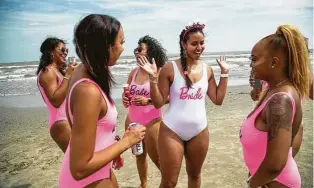  ?? Marie D. De Jesús / Staff photograph­er ?? Wearing a white swimsuit as the bride-to-be, Kristin Ozan, center, enjoys some beach time with her bridesmaid­s during a bacheloret­te outing in Galveston on Saturday. Ozan will be getting married in November.