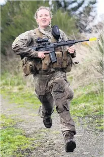  ?? PHOTO: JOHN COSGROVE ?? Racing ahead . . . Lance Corporal Kate DownieMelr­ose, a Dunedinbas­ed insurance industry manager, races between two of the examinatio­n stages on the hills behind the Tapanui Agricultur­al Centre, during a top soldier selection training day held by Bravo Company 2/4 RNZIR.