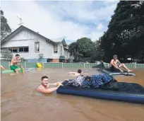  ?? Picture: EPA ?? STREETS AWASH. Residents negotiate floodwater­s in central Lismore, New South Wales, Australia, yesterday. The Wilsons River breached its banks.