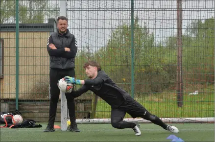  ??  ?? John Gibson, a former Scottish profession­al footballer, is founder of the John Gibson Goalkeepin­g Academy, passing on tips to young footballer Lewis Mcpherson