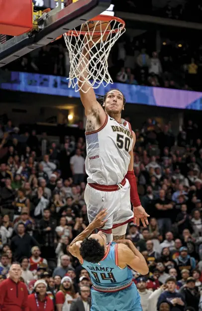  ?? ?? Dec. 25: Denver’s Aaron Gordon hammers a ferocious and ill-intentione­d dunk on the head of Landry Shamet of the Phoenix Suns during overtime of Denver’s 128-125 win at Ball Arena on Christmas Day.