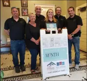  ?? Sandy Schneider-Engle / Courtesy photo ?? Owners Ron and Vicki Edwards, their daughter Angie Edwards-Aker, General Manager Zach Deal, Assistant General Manager Dylan Prevost, and Assistant General Manager and Produce Manger Tony Ertle at Edwards Right Price Market stand with their July Business of the Month sign inside Fort Morgan's City Hall.