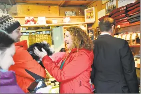  ??  ?? Rep. Elizabeth Esty, D-Conn., says hello to Goshen’s Ed Cotler and his dog, Watson, during Friday’s visit to Thorncrest Farm & Milk House Chocolates.