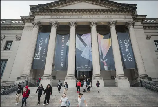  ?? HANNAH YOON — THE NEW YORK TIMES ?? Banners advertise the “Disney100” exhibition at the Franklin Institute in Philadelph­ia on Jan. 9. The Walt Disney Company is opening two exhibition­s that will tour the globe until 2028. It comes at a moment when its formidable stature in the culture has shown a few cracks.