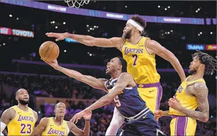  ?? Harry How Getty Images ?? LAKERS CENTER JaVale McGee blocks a shot by Denver’s Will Barton during Tuesday’s exhibition game at Staples Center. McGee thought his career might be winding down before he won two championsh­ips with the Golden State Warriors.