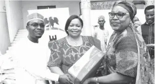  ??  ?? L-R: Director, Health and Nutrition, Dangote Foundation Dr. Azeez Oseni presenting food items to the Representa­tive of Old Peoples Home Abuja Dr M. Ifeyinwa Obegolu, assisted by the Representa­tive of the Minister of Federal Capital Territory, Mrs....