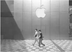  ??  ?? This photo shows people walking past an Apple store in Beijing. Enterprisi­ng internet users in China fear the tools they use to tunnel through the country’s “Great Firewall” may soon disappear, as Beijing tightens its grip on the web. — AFP photo