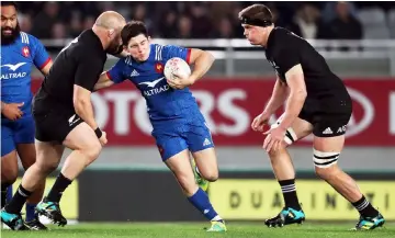  ??  ?? France’s Anthony Belleau (centre) fights off the tackle of New Zealand’s Owen Franks (left) during the first rugby Test match between the New Zealand All Blacks and France at Eden Park in Auckland. — AFP photo