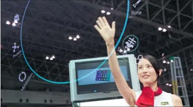  ?? PROVIDED TO CHINA DAILY ?? An exhibitor demonstrat­es Lenovo’s prototype Think Mirror at an industry expo in Tokyo.