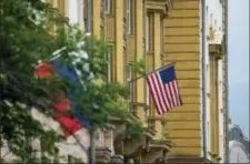  ?? ALEXANDER ZEMLIANICH­ENKO - THE ASSOCIATED PRESS ?? U.S. and Russian flags hung at the U.S. Embassy in Moscow, Russia, Friday. Russia’s Foreign Ministry on Friday ordered a reduction in the number of U.S. diplomats in Russia and said it was closing down a U.S. recreation retreat in response to fresh...