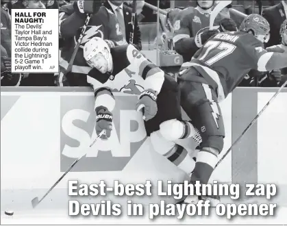  ??  ?? HALL FOR NAUGHT: The Devils’ Taylor Hall and Tampa Bay’s Victor Hedman collide during the Lightning’s 5-2 Game 1 playoff win.