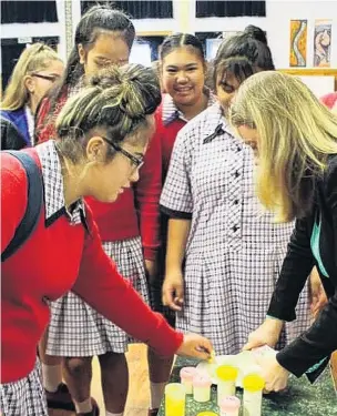  ?? PHOTOS: SUPPLIED ?? Future teaching . . . Katharine Holdsworth, a food process technologi­st at Fonterra’s Edendale dairy factory, shows year 10 pupils from Qouthland Girls’ High Qchool some cheese quality control techniques during technology during a Qouthland Youth Futures employer talk earlier this year.