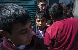  ?? OLIVER DE ROS — THE ASSOCIATED PRESS ?? Central American migrants sent from the United States walk out into the open air after arriving in Guatemala City.