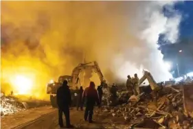  ?? AP PHOTO/ALEXEI ALEXANDROV ?? Donetsk’s emergency employees work Monday in the rubble of a shopping center destroyed by what Russian officials claim was shelling by Ukrainian forces, in Donetsk, in Russian-controlled Donetsk region, eastern Ukraine.