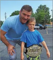  ?? MARK PODOLSKI — THE NEWS-HERALD ?? Stipe Miocic and Sam Podolski, weeks after Miocic won the UFC heavyweigh­t championsh­ip belt in 2016.