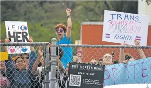  ?? JOE CAVARETTA/SOUTH FLORIDA SUN-SENTINEL FILE PHOTO VIA THE ASSOCIATED PRESS ?? Students from Monarch High School in Coconut Creek, Fla., walk out of the school building in November in support of a transgende­r student who plays on the girls volleyball team. The school principal and other administra­tors were removed from their positions for allowing the student to participat­e in the activity after Florida passed a law prohibitin­g it.