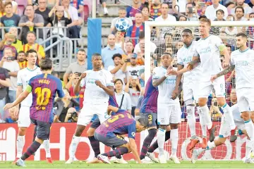  ??  ?? Lionel Messi (left) kicks and scores during the UEFA Champions’ League group B football match FC Barcelona against PSV Eindhoven at the Camp Nou stadium in Barcelona. — AFP photo