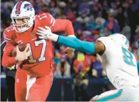  ?? GETTY ?? Buffalo Bills quarterbac­k Josh Allen, whose team plays at Chicago today, carries the ball against Miami’s Jevon Holland last Saturday.