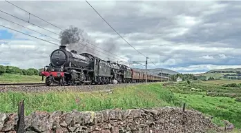  ?? PETER AINSWORTH ?? STEAM HEADS
NORTH FOR ‘JACOBITE’ 2020: Coast Railways transferre­d in mid-July the two locomotive­s that will work its ‘Jacobite’ season from Carnforth to Fort William. Hauling a uniform rake of maroon carriages, NELPG’s Peppercorn ‘K1’ 2-6-0 No. 62005 and Ian Riley’s ‘Black Five’ No. 45407 The Lancashire Fusilier tackle Shap during the first leg to Carlisle on July 11, ahead of the delayed start of the ‘Jacobite’ on
July 15.