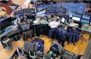  ?? BRENDAN MCDERMID/REUTERS ?? Traders work on the floor at the New York Stock Exchange (NYSE) in New York, U.S., Sept. 9.