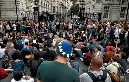  ?? AP ?? Anti-brexit supporters gather outside the prime minister’s residence 10 Downing Street in London.