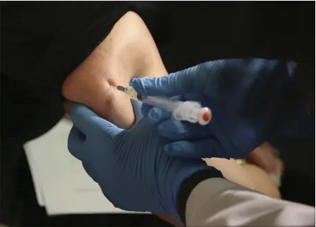  ?? SETH WENIG, FILE — THE ASSOCIATED PRESS ?? A woman receives a measles, mumps and rubella vaccine at the Rockland County Health Department in Pomona, N.Y. Measles outbreaks in the U.S. and abroad are raising health experts’ concern about the preventabl­e, once-common childhood virus.